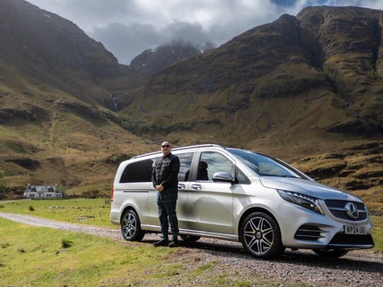 Pitlochry Transfers and Tours V Class with driver in foreground in Scottish Landscape