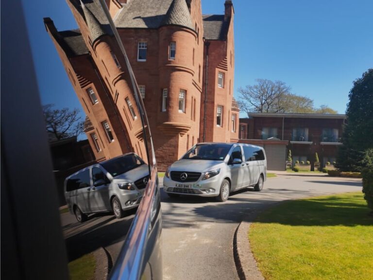 Hotel reflected in privacy glass of Pitlochry Transfers & Tours Mercedes