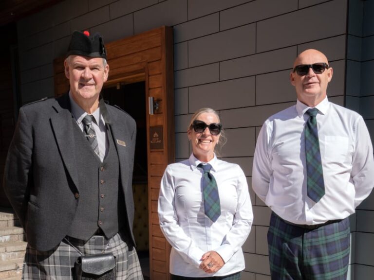 Two drivers and the doorman at the entrance to the hotel