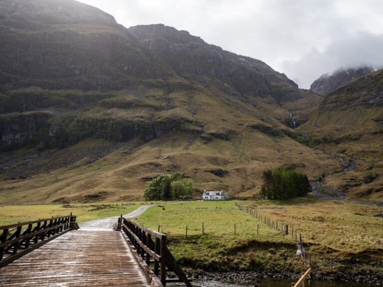 View of wooden bridge leading to remote cottage